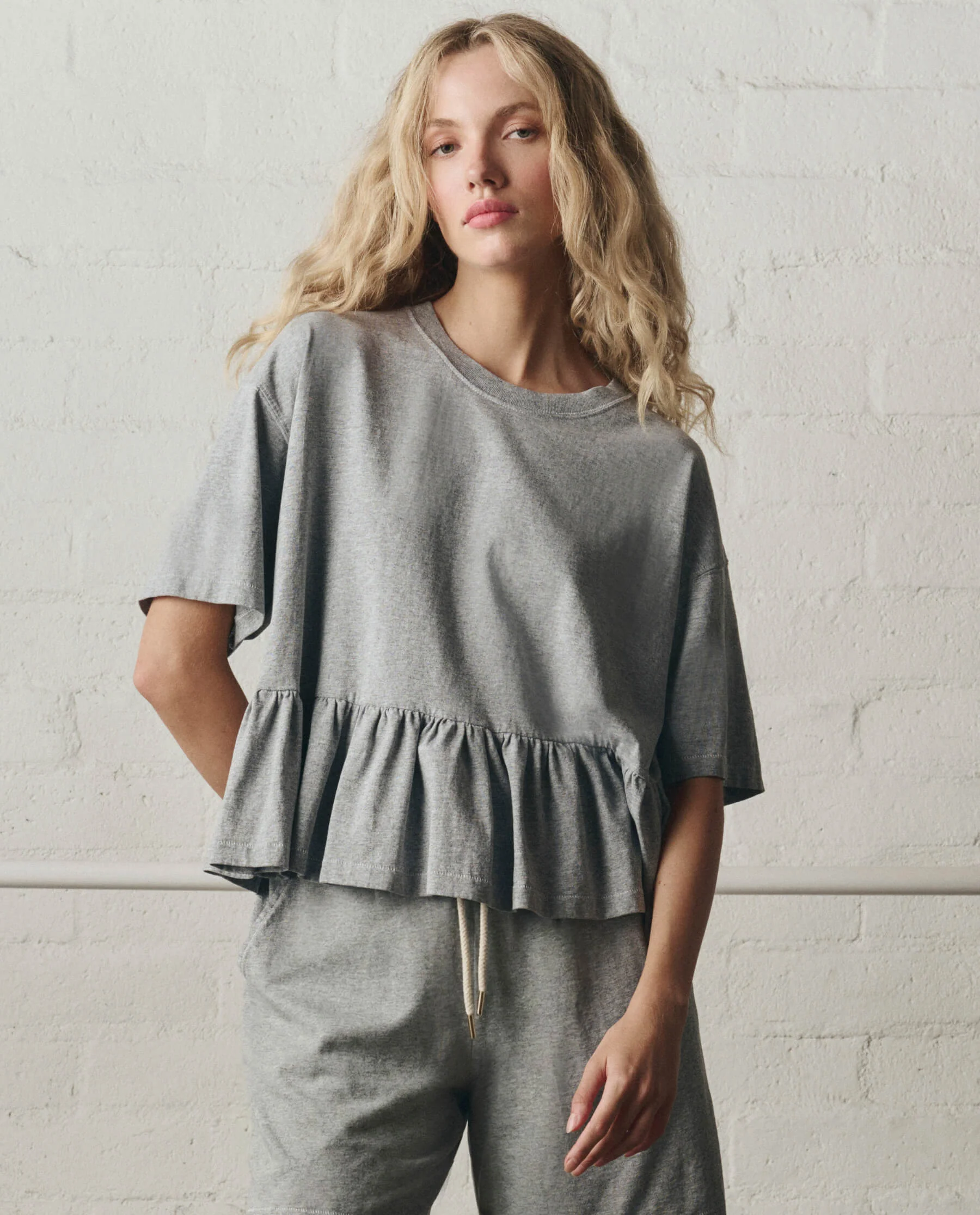 943-the-oversized-ruffle-peplum-tee.-heather-grey-1.webp The Oversized Ruffle Peplum Tee. -- Heather Grey