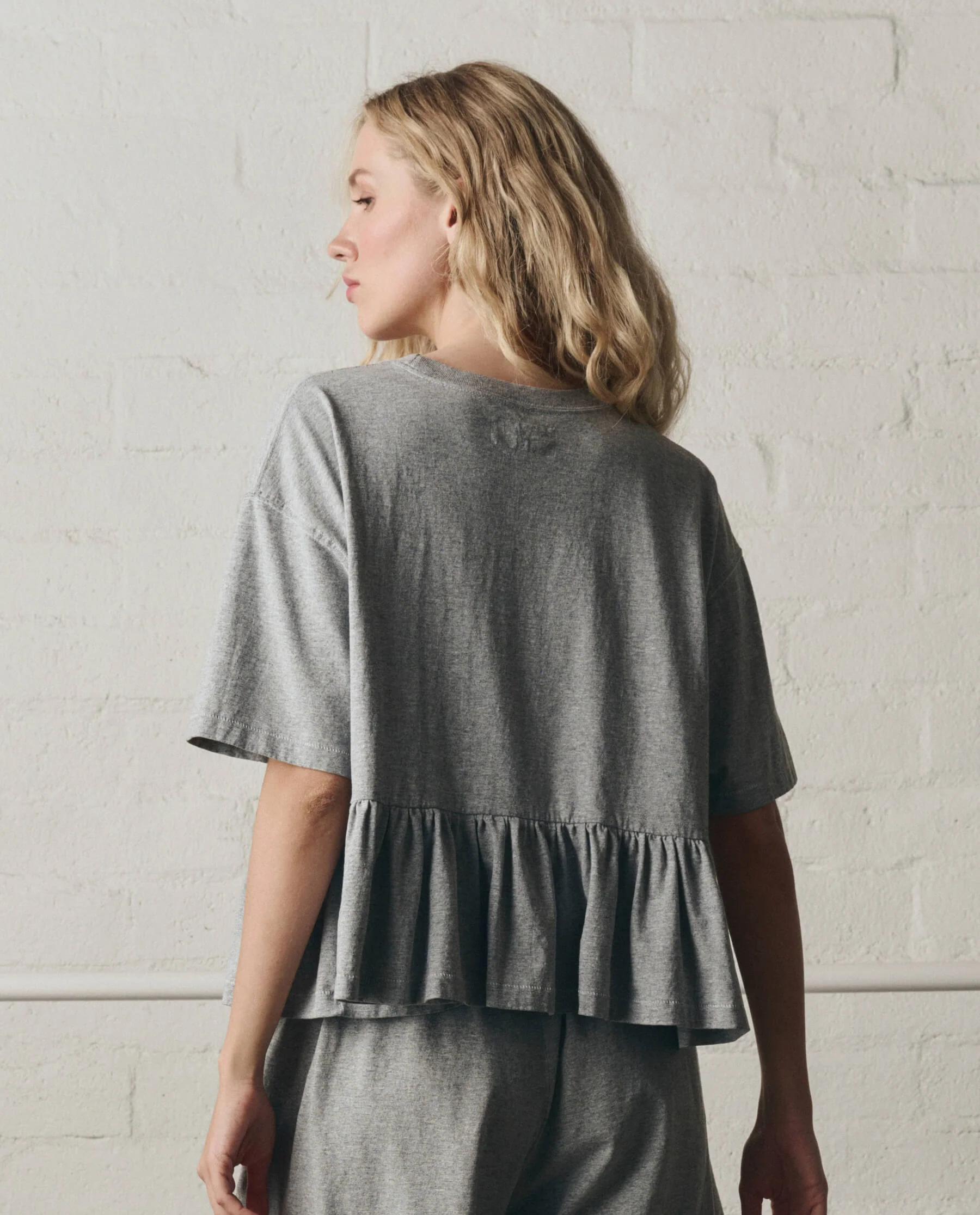 943-the-oversized-ruffle-peplum-tee.-heather-grey-3.webp The Oversized Ruffle Peplum Tee. -- Heather Grey