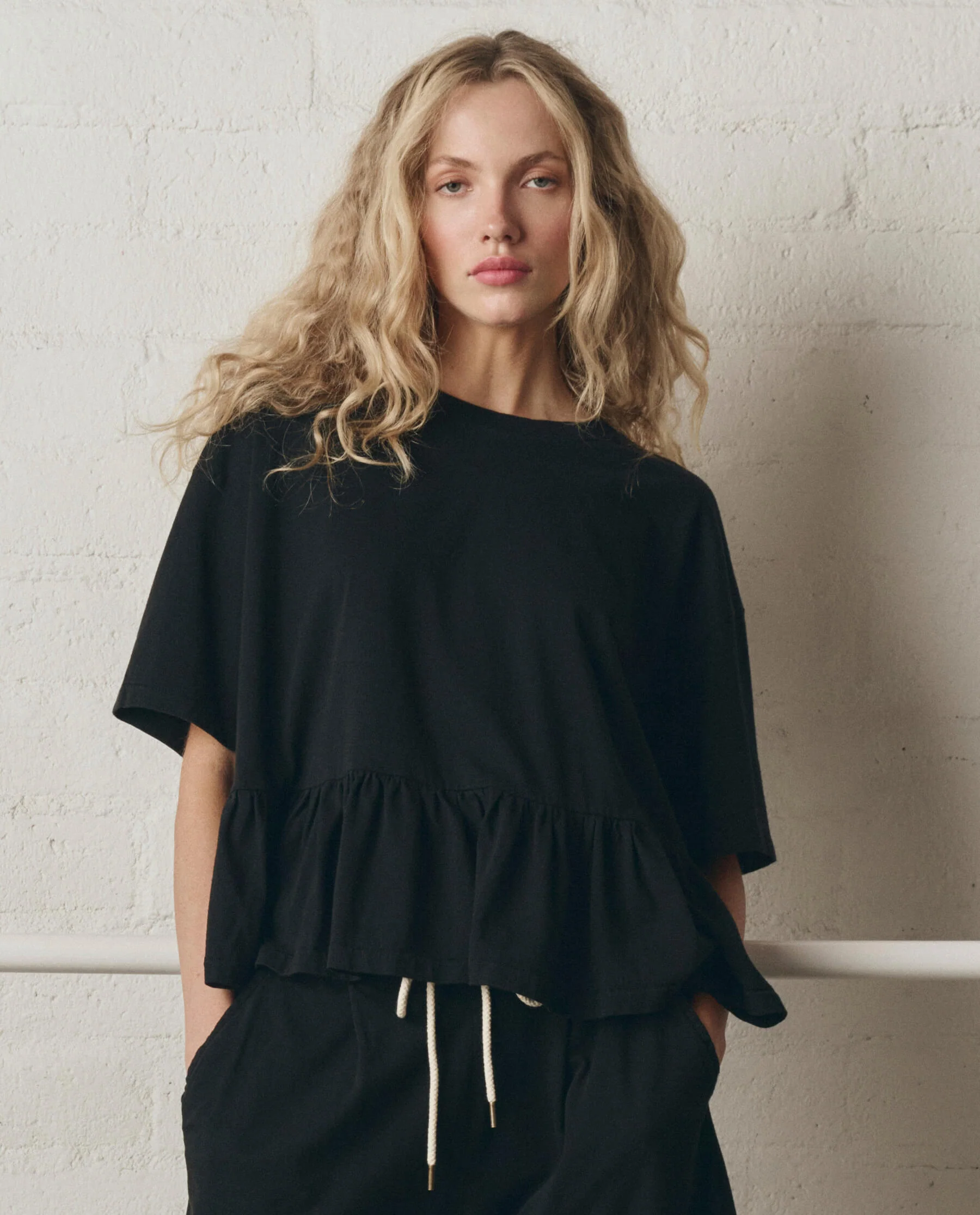 968-the-oversized-ruffle-peplum-tee.-true-black-1.webp The Oversized Ruffle Peplum Tee. -- True Black