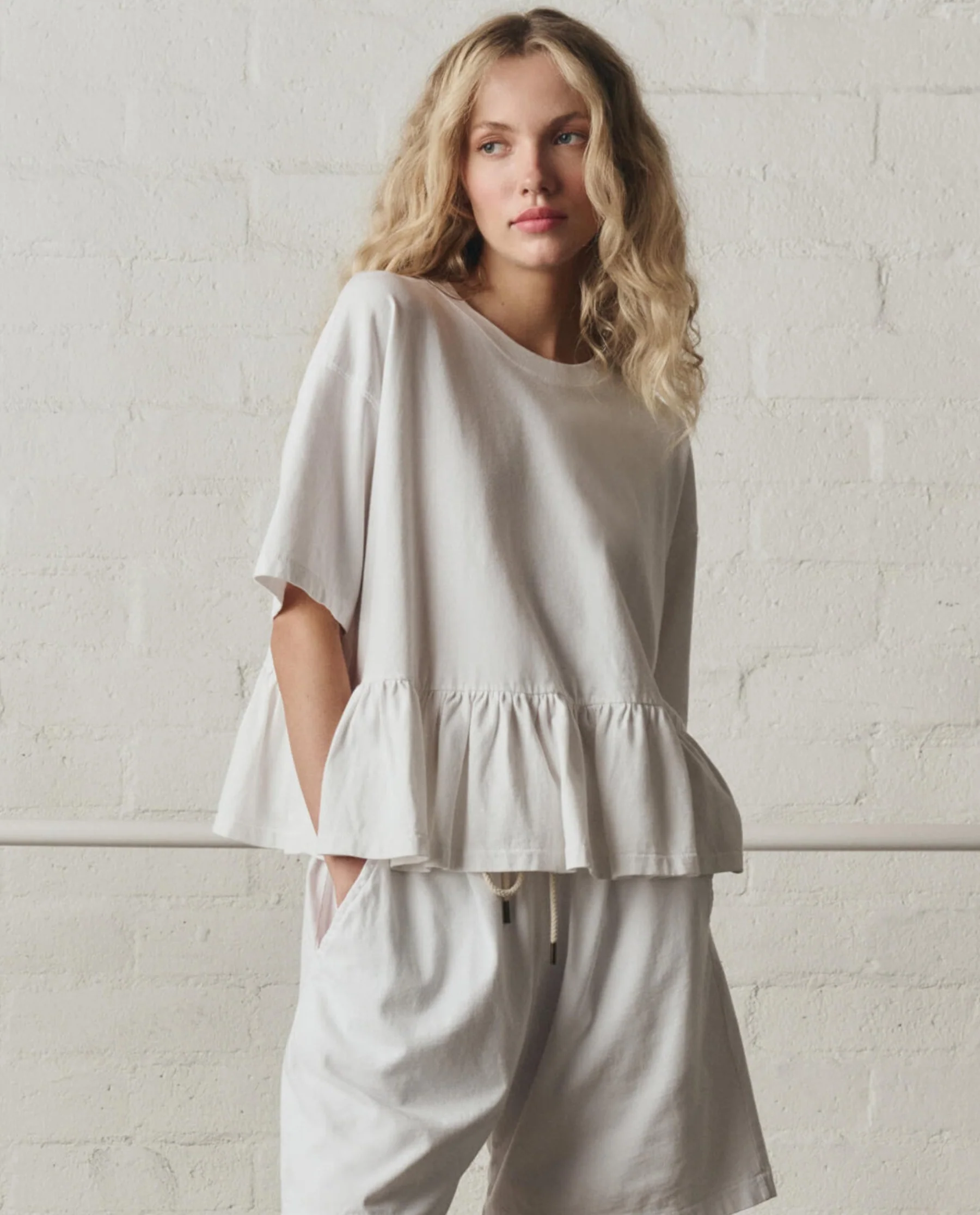 973-the-oversized-ruffle-peplum-tee.-true-white-1.webp The Oversized Ruffle Peplum Tee. -- True White