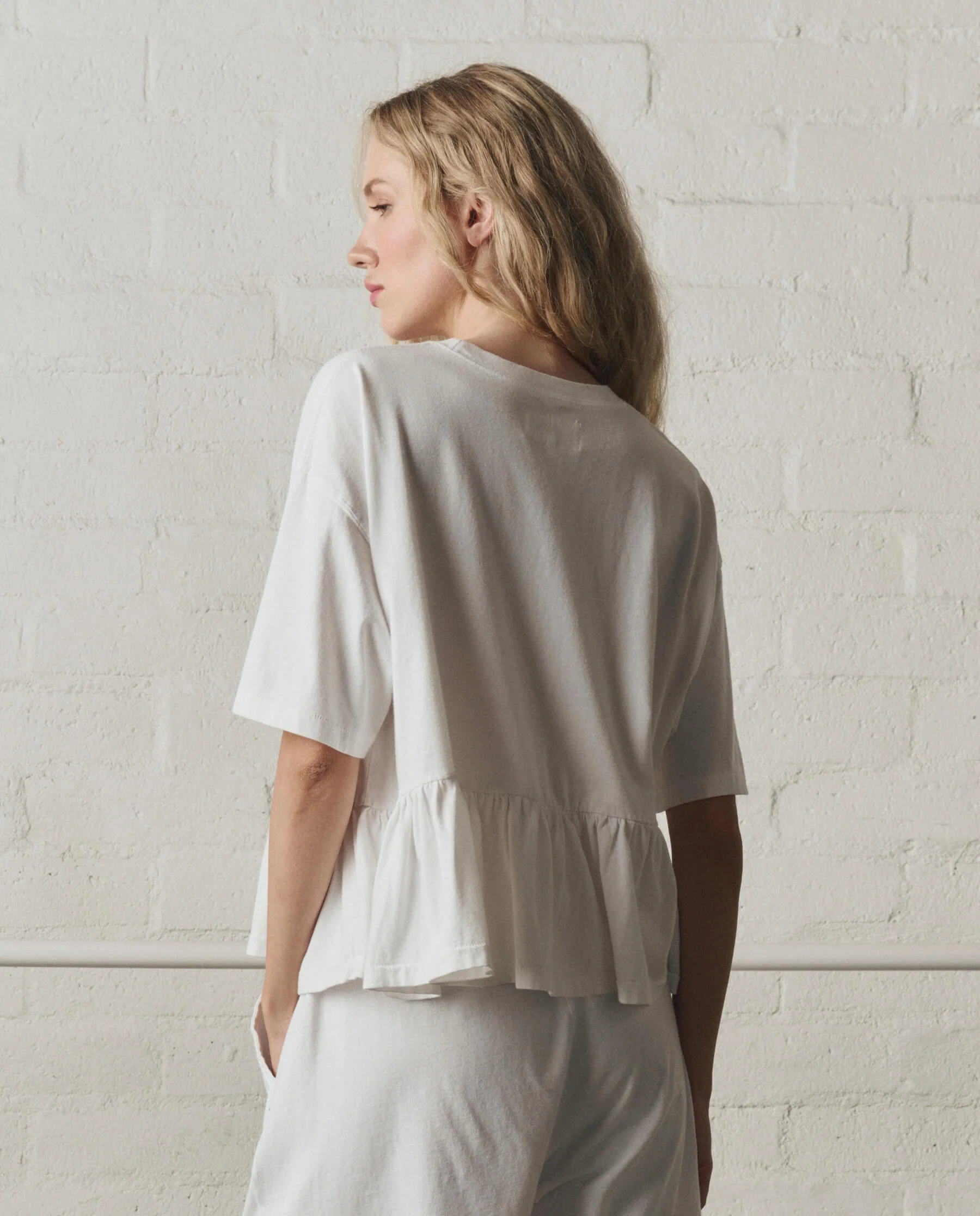 973-the-oversized-ruffle-peplum-tee.-true-white-4.webp The Oversized Ruffle Peplum Tee. -- True White